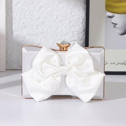 Elegant white satin bow clutch bag with gold chain