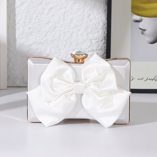 Elegant white satin bow clutch bag with gold chain