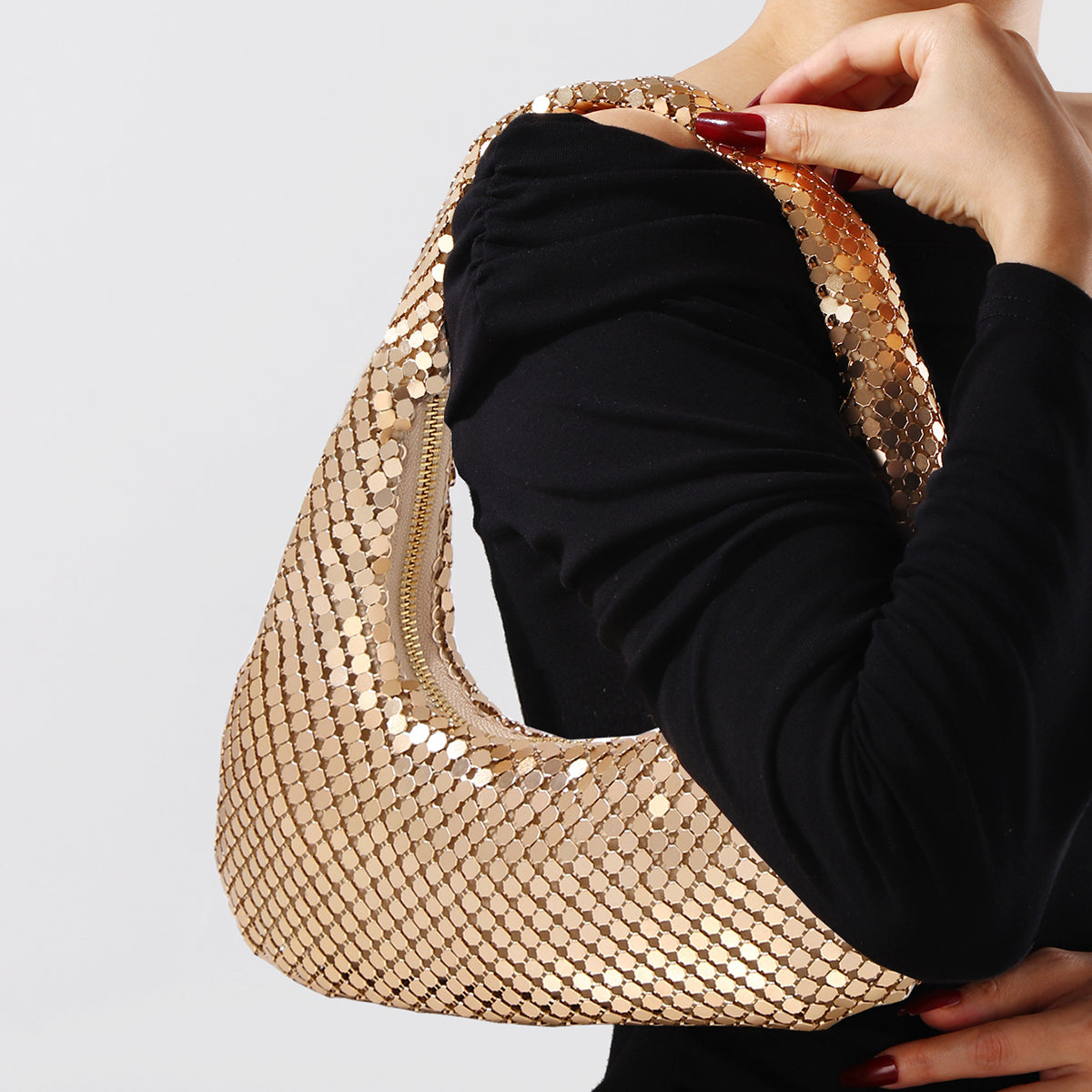 Gold shoulder bag with phone size comparison