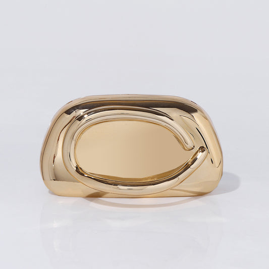 Sculptural gold acrylic clutch bag with detachable chain strap